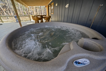 Your private hot tub sits on the deck with plenty of privacy and views of the surrounding forest.