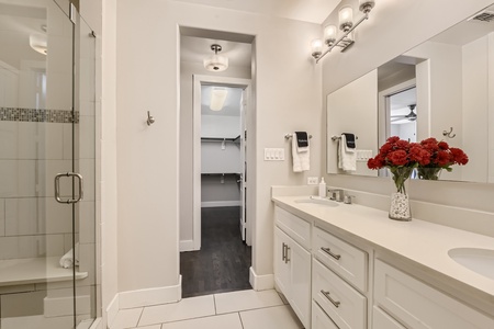 Bathroom with shower, sink and closet