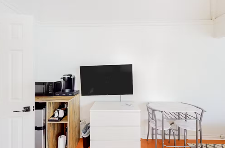 Bedroom view with mini fridge, coffee and microwave