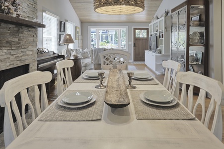 Rustic Coastal Dining table with place settings. The front door and living area in the background.