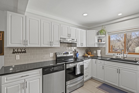 Kitchen with dishwasher, oven, and stove