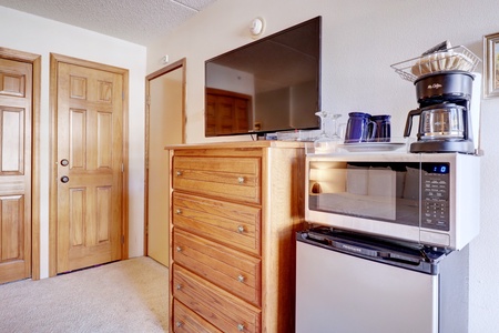 Mini fridge, microwave, coffee maker, and TV make for a cozy area for relaxing after skiing.