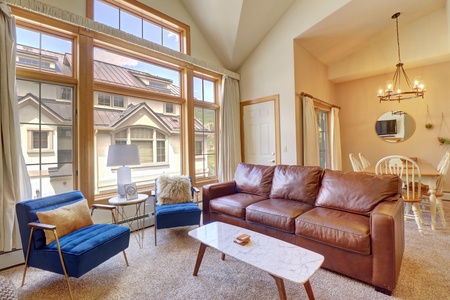 Cozy open concept living area offers large windows allowing ample natural light to come in.