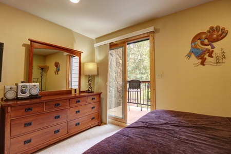 The room has a small private balcony which offers seating great wooded views into the backyard area at Copper Mountain Inn.