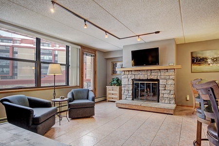 Living area with seating, fireplace, and TV.