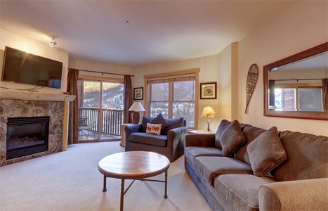 Cozy living room area featuring a private balcony.