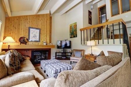 Cozy living room with fireplace, TV, and multiple seating options.