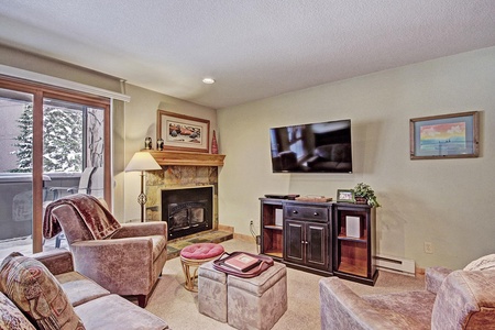 A cozy living room with a fireplace and TV.