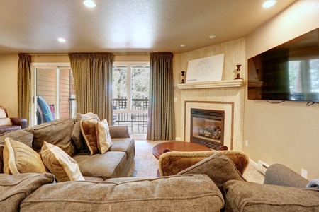 Cozy sectional sofa looking out onto balcony.