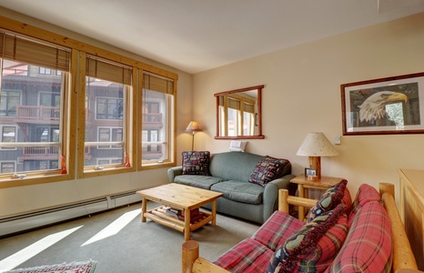 Living room area featuring large windows.