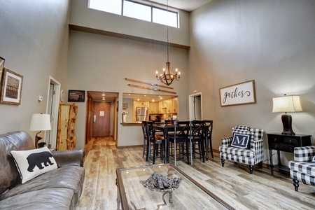 Open concept living area with tall ceilings and natural light coming in.