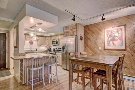 Open concept kitchen with dining room table and breakfast bar area.