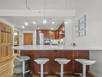 Bar stool dining area looking into kitchen.