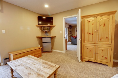 Looking out to the TV, mini fridge. (Door shown in photo will be closed/locked off)