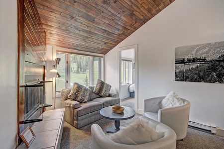 The living room offers lots of seating options and large windows with great views of the ski slopes.