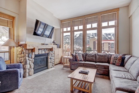 Living room features a cozy fireplace and large TV