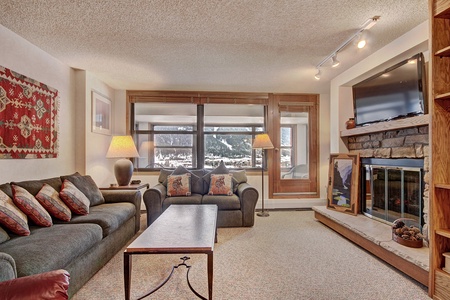 A cozy living room featuring a fireplace and TV.