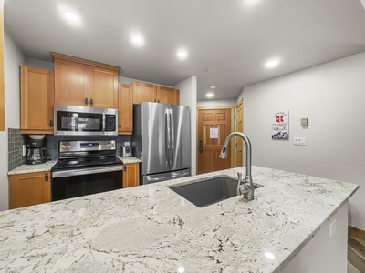 Nicely updated kitchen looking towards entryway.