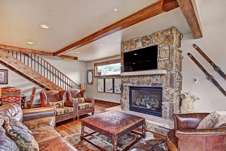 The living room offers multiple seating options, a fireplace, and TV.