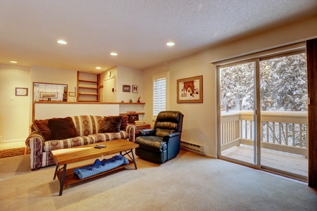 Open concept living room with a private balcony.