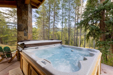 A hot tub on a wooden deck with bubbling water, surrounded by trees and nature.