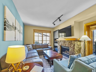 Living room features a nice TV and fireplace.