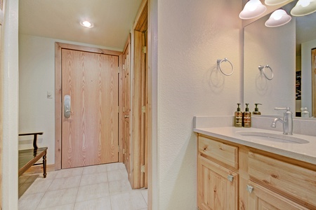 Hallway features a sink and storage underneath.