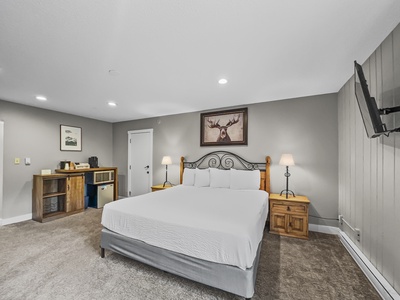 King bed with mini fridge, microwave, and coffee maker in the corner.