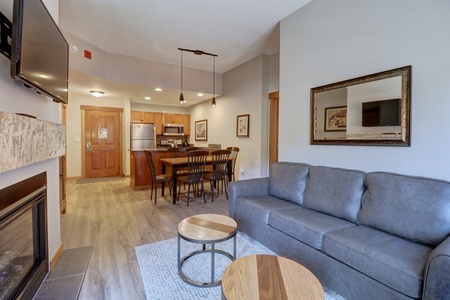 Living room features a couch, chair, and tables.