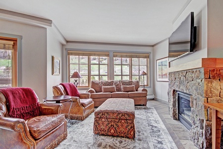 Living room features large windows letting in ample light.