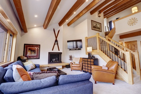 Open concept living area featuring a large TV and cozy fireplace.