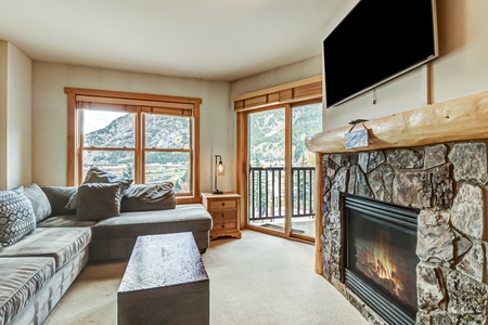 Bright and airy living room with comfortable sectional, Smart TV, and fireplace