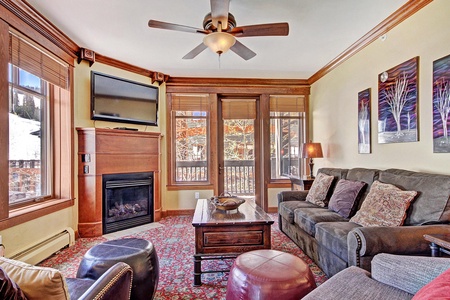 Looking over to the fireplace and TV, with access to the private balcony to the right.