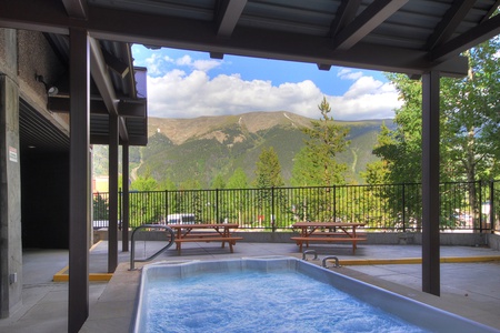 Outdoor communal hot tub with a seating area.