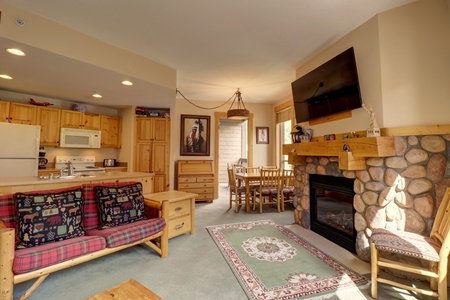 Cozy living area with open concept dining and kitchen.