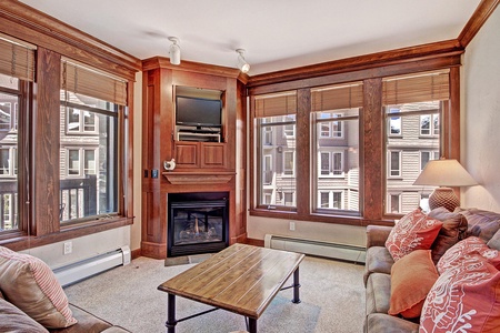 Cozy living room with TV, fireplace. and access to a private balcony!