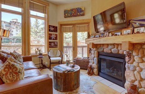 Vibrant living room with fireplace and large TV.