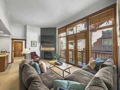 Cozy living room features a large TV and fireplace.