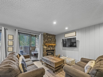 Cozy living room area with fireplace and TV.