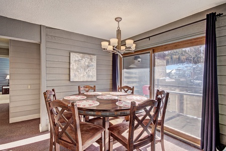 Large dining room table with access to the patio in the background.