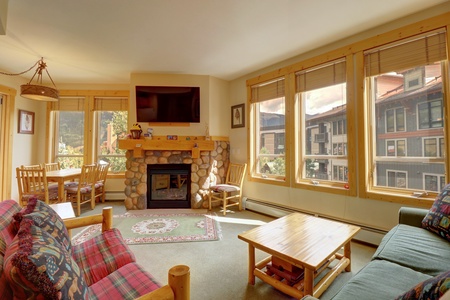 Living room features a queen sleeper sofa, cozy fireplace, and large TV.