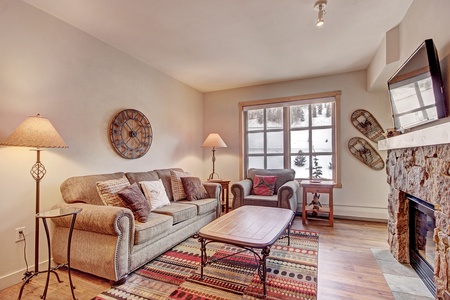 Cozy living room features queen sized sleeper sofa.