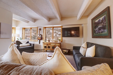 Living room area offers great mountain views, a large TV, and ample seating for the whole family.