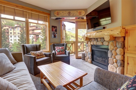 Cozy living room with private balcony access and fireplace.