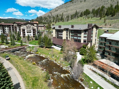 Backyard view of Bridge End with a creek flowing through.