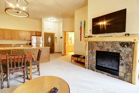 Open concept living area with fireplace and mounted TV above