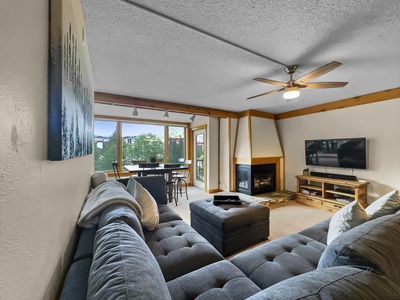 Large sectional sofa looking towards patio access, fireplace, and TV