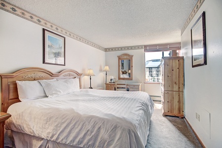 Hotel room featuring a cozy king bed.