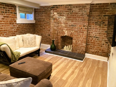 Living room with sofa that pulls out into a Queen bed. Linens and pillows provided. With Smart TV