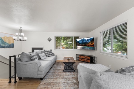 Gather in the inviting living room with plush seating, a Smart TV, and shelves stocked with nearly every game imaginable for endless fun.